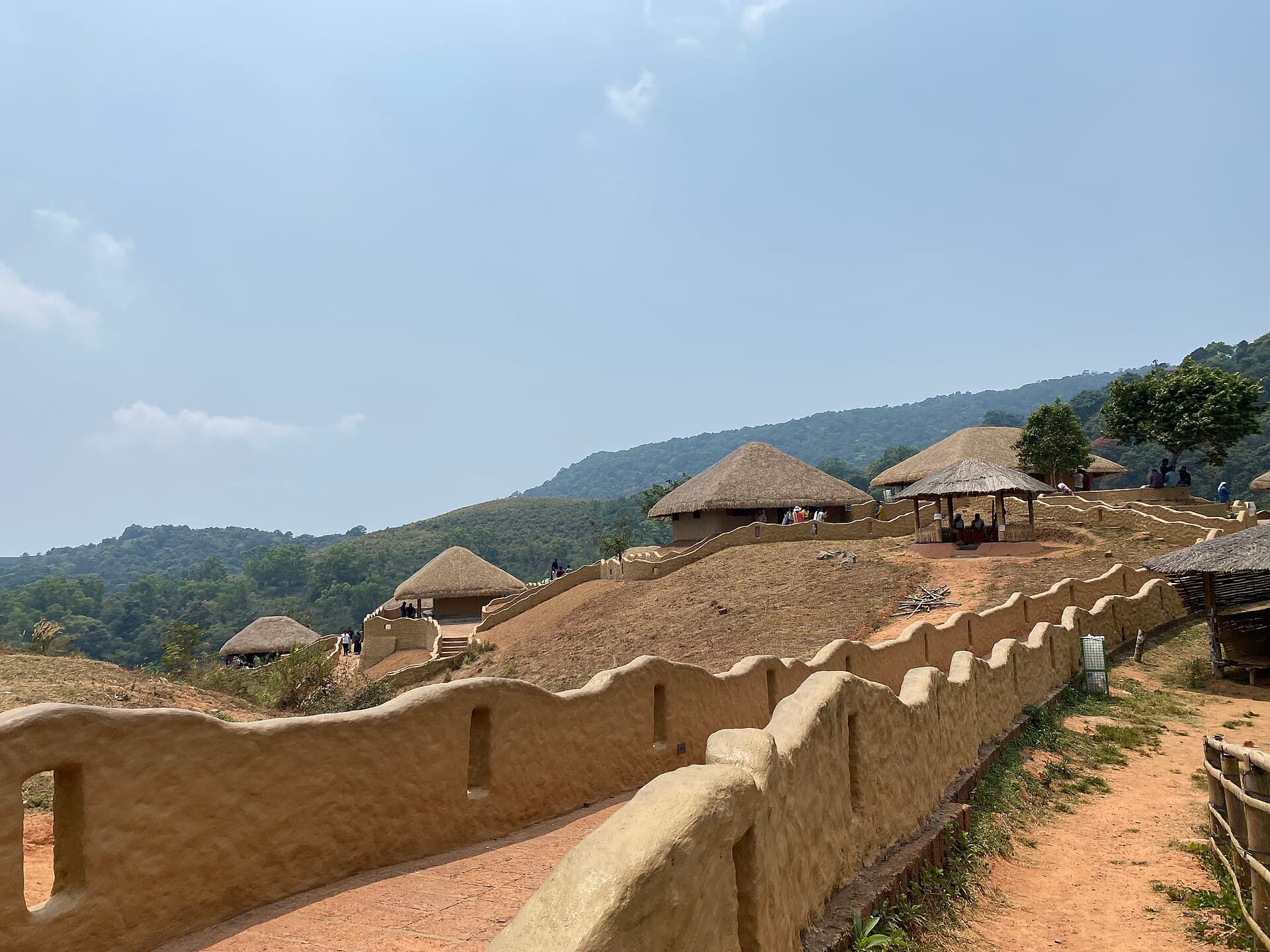 Thatched huts and mud walls at the En Ooru heritage village in Wayanad.